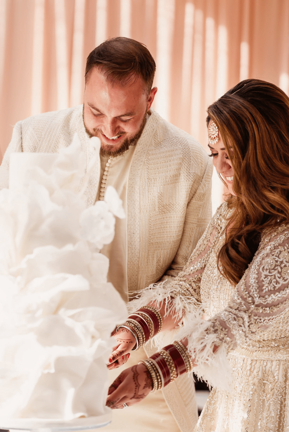 Fusion wedding couple cutting cake